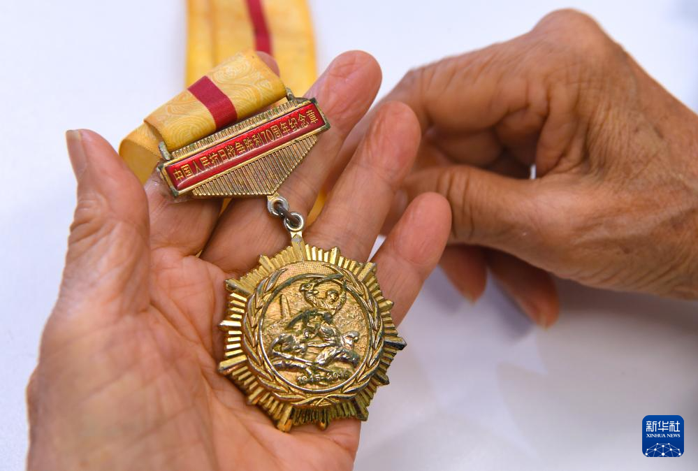 6月24日，在香港屯門欣田邨服務(wù)處，90歲的抗日老戰(zhàn)士林珍展示她榮獲的紀念章。新華社記者 陳鐸 攝