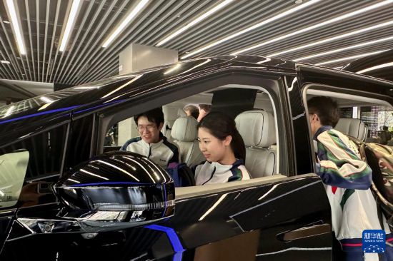 澳門坊眾學(xué)校學(xué)生在廣州體驗(yàn)一款電動(dòng)汽車（3月21日攝）。新華社記者 郭雨祺 攝