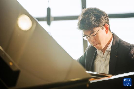 　　7月25日，沈靖韜在香港演藝學(xué)院的琴房里彈奏鋼琴。新華社記者 朱煒 攝